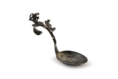 null Silver tea spoon, the spoon embossed with a flower and rocaille, the curved...