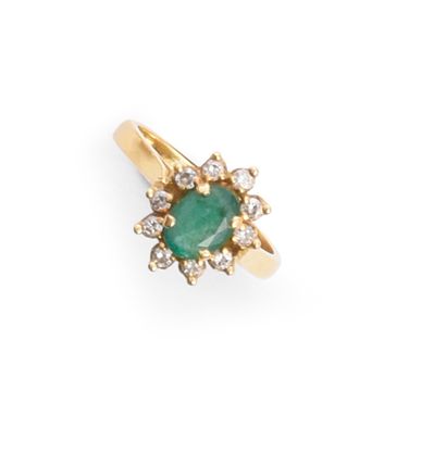 Daisy ring set with an oval faceted emerald...