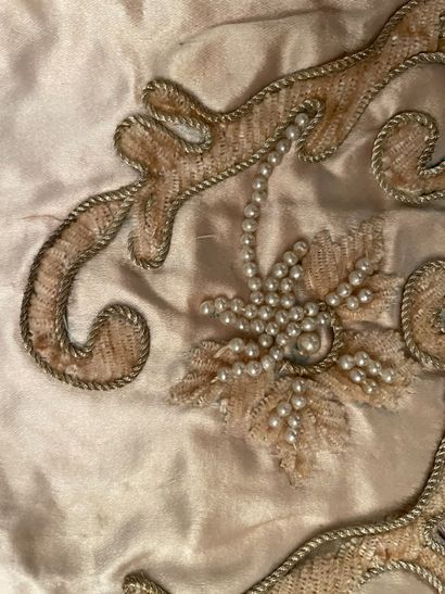 null Parts of an embroidered ball gown, circa 1900, flounce and pair of cream satin...