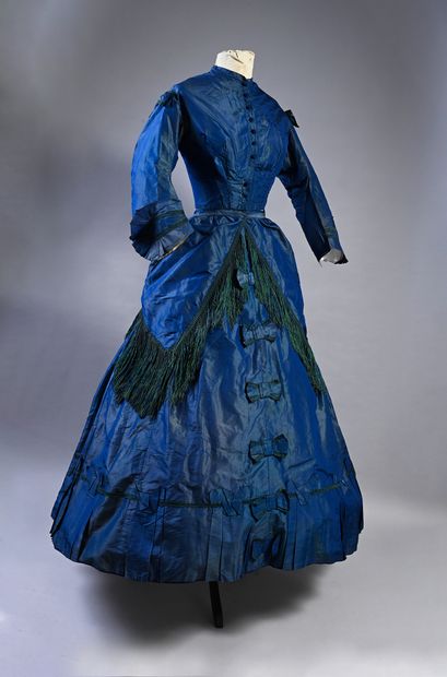 null Afternoon dress, circa 1860, blue change silk taffeta; stapled bodice trimmed...