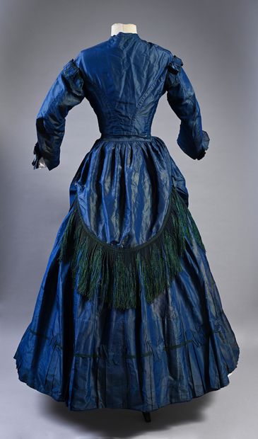 null Afternoon dress, circa 1860, blue change silk taffeta; stapled bodice trimmed...