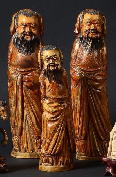 null TROIS STATUETTES de sages en ivoire à patine jaune teintée et craquelée à l'imitation...