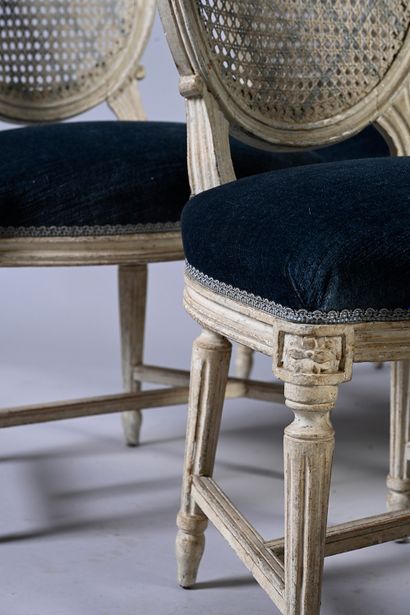 null Suite of twelve chairs in molded wood and white lacquered, the medallion back...