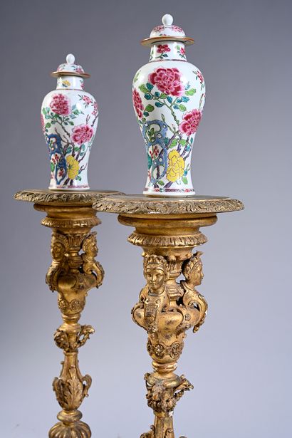null Pair of carved and gilded wood torch-doors, the round leafy tray resting on...