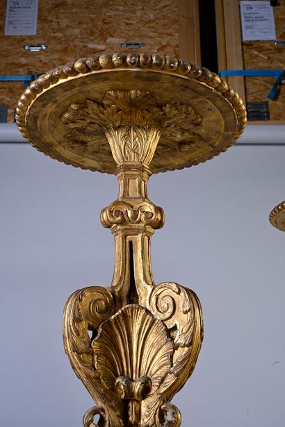 null Pair of large carved and gilded wood torchieres, the round gilded tray rests...