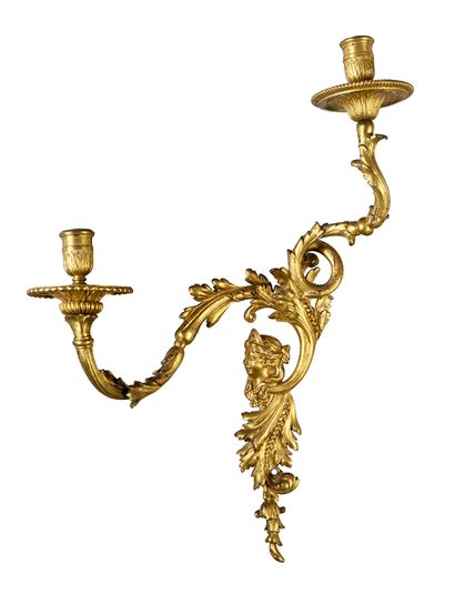 null Pair of chased and gilded bronze sconces, with two scrolled arms of acanthus...