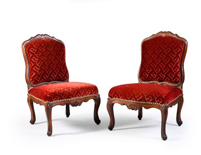 null Pair of molded and carved walnut armchairs, the cabriolet back, the belt decorated...