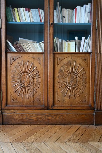 null Carved oak bookcase opening with two glass doors decorated with vellums and...