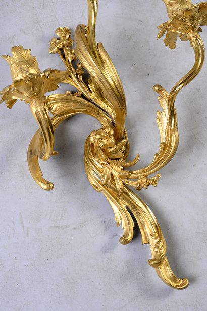 null Pair of chased and gilt bronze sconces with three swirling arms of light formed...
