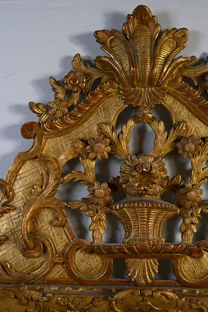 null Gilded wood mirror with carved shells and foliage, the openwork pediment decorated...