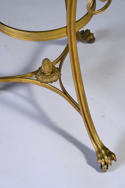 null Gilt bronze and chiseled pedestal table, the granite top, the curved uprights...