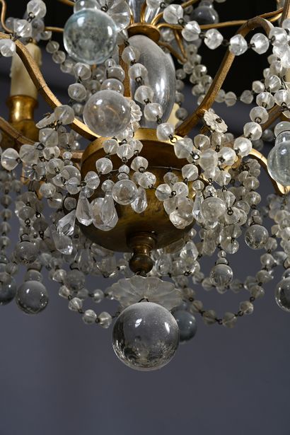 null A bronze chandelier with eight arms of light richly decorated with pendants...