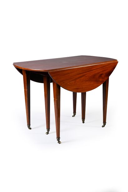 null Mahogany and mahogany veneer shutter table. It rests on six legs with gilt bronze...