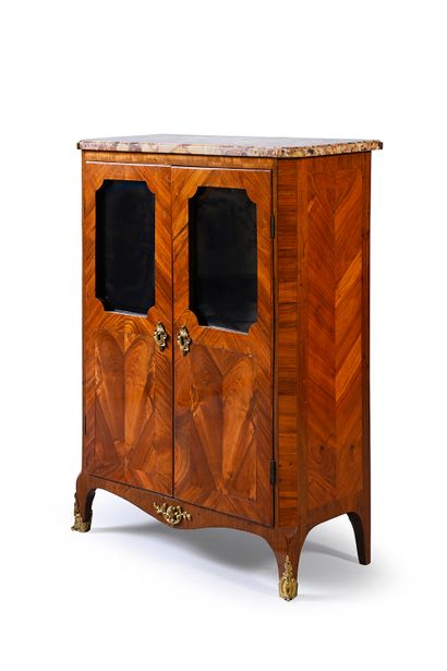 null Low bookcase in marquetry of veneer opening with two glazed doors in high part....