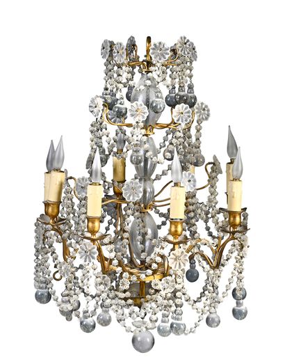 null A bronze chandelier with eight arms of light richly decorated with pendants...