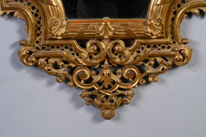 null Pair of mirrors in carved and gilded wood and openwork in the form of an escutcheon...