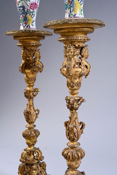 null Pair of carved and gilded wood torch-doors, the round leafy tray resting on...