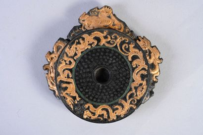 CHINE, XXe siècle Ink stone in the form of a bi archaic disc, with a decoration in...