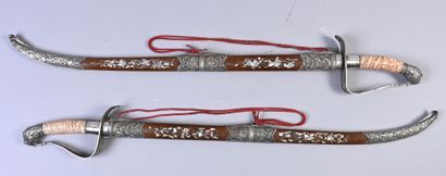 VIETNAM, XIXe siècle Rare and important pair of ceremonial sabers, the wooden scabbards...