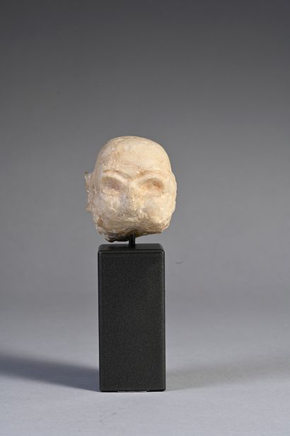 null Head of a bearded bald man whose hollowed-out eyes were inlaid. Beige calcite....