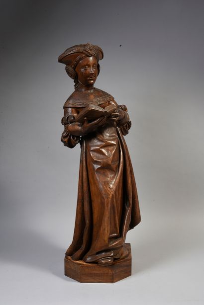 null Holy woman reading in carved walnut. Standing, holding an open book in front...