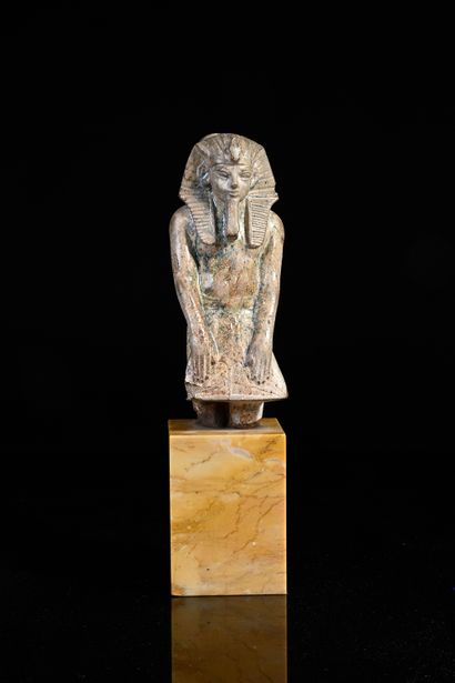 null Statuette in the name of Amenophis III in green glazed steatite.
H. 12.7 cm.
Egyptian...