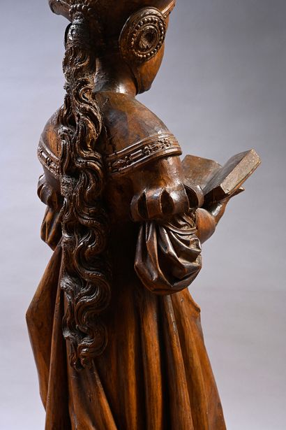 null Holy woman reading in carved walnut. Standing, holding an open book in front...