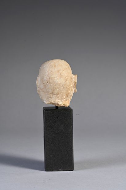 null Head of a bearded bald man whose hollowed-out eyes were inlaid. Beige calcite....