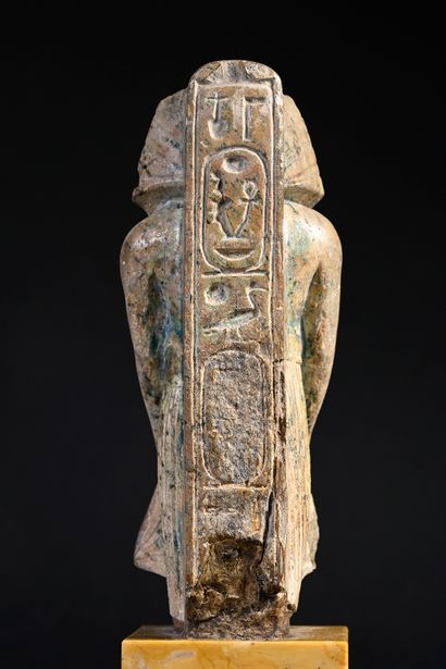 null Statuette in the name of Amenophis III in green glazed steatite.
H. 12.7 cm.
Egyptian...