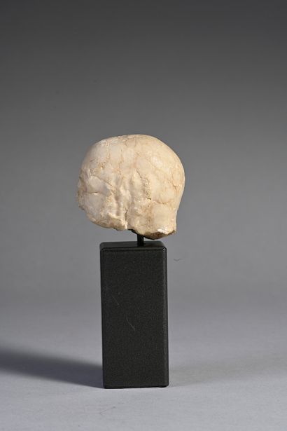 null Head of a bearded bald man whose hollowed-out eyes were inlaid. Beige calcite....