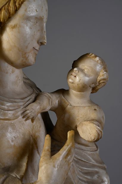 null Virgin and Child in alabaster carved in the round with gilded and engraved parts,...