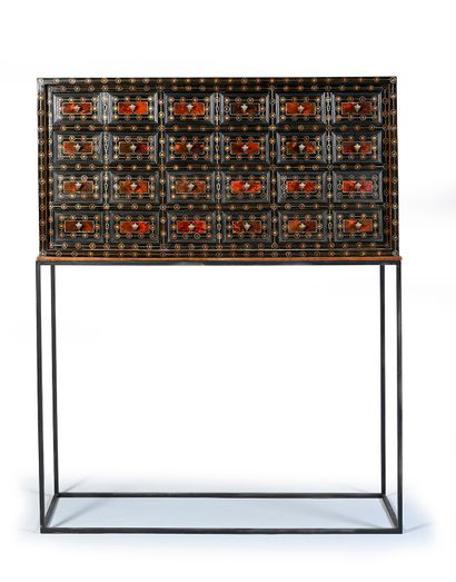 null Rectangular cabinet opening to 12 drawers simulating 24, ornamented with red...