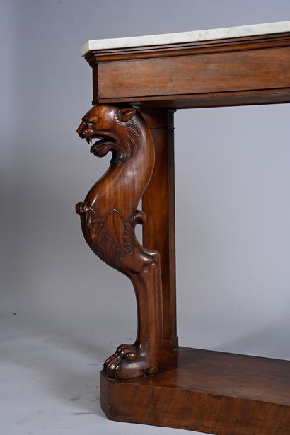 null Mahogany and mahogany veneer console, carved and molded, the feet on plinths...