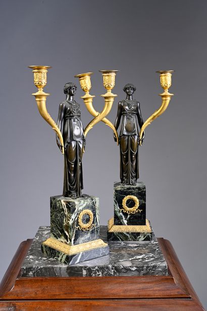 null Pair of candelabra in chased patinated and gilded bronze decorated with a vestale...