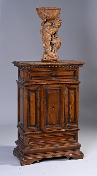 null Mobileto in walnut, opening to a drawer and a door in front, frieze of lunules;...