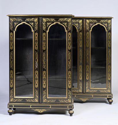null Pair of blackened wood display cabinets opening to two glazed and arched leaves,...