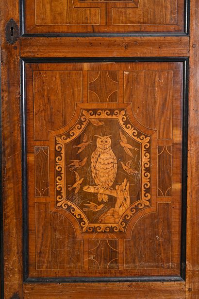 null Walnut cabinet, blackened wood opening to two doors with marquetry decoration...