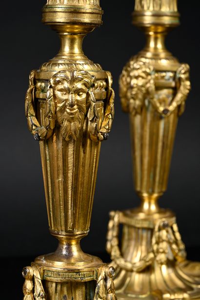 null Pair of Greek-style torches in chased and gilded bronze resting on a doucine...