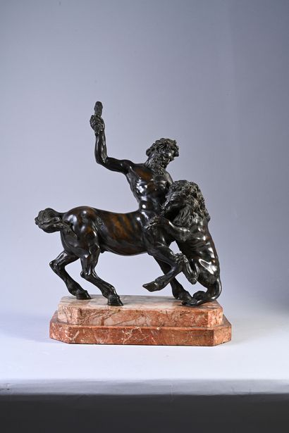 null The centaur Chiron attacking a lion bronze group with brown patina.
After the...