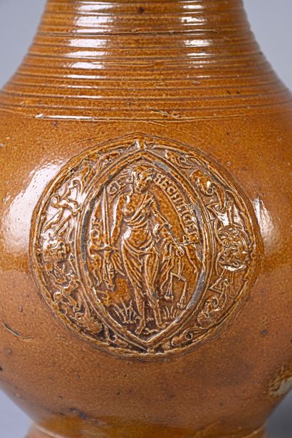 null Enamelled stoneware jug of pan form, decoration in application of medallion...