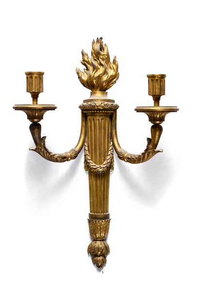 null Pair of sconces in chased and gilded bronze with two arms of light, with a base...