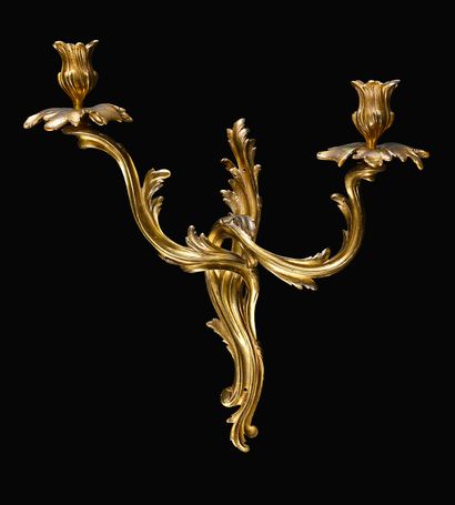null Pair of ormolu rocaille sconces with two moving and foliated arms of light.
Louis...
