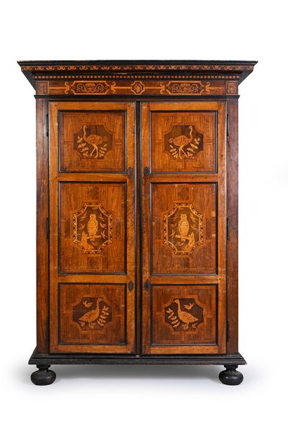 null Walnut cabinet, blackened wood opening to two doors with marquetry decoration...