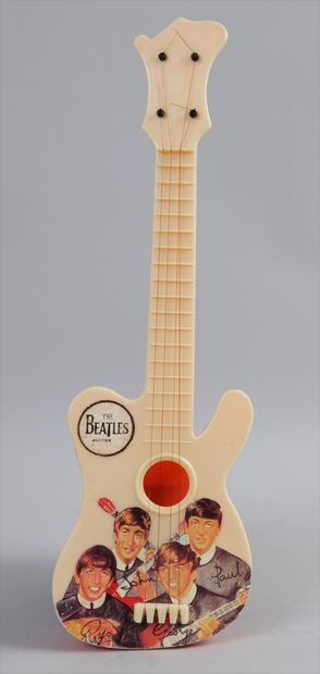 THE BEATLES: Une guitare en jouet offert...