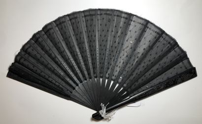null Sequins, Europe, circa 1900
Folded fan, the black silk leaf sewn with a plumetis...