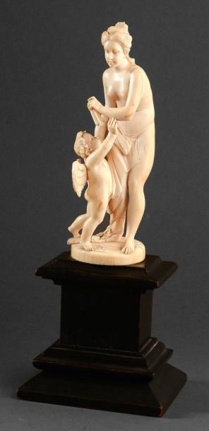 null Groupe en ivoire Vénus et Cupidon. Il représente Vénus drapée à l'Antique tenant...
