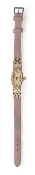 null Une montre bracelet de dame en or gris, cadran de forme ovale, ceinturé de petits...