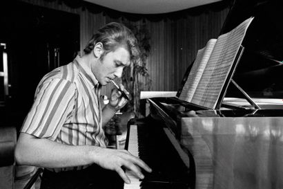 Hallyday, Johnny Johnny Hallyday au piano chez lui à Neuilly. 1965. Photographie...