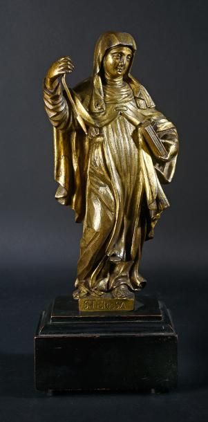 null Statuette en bronze ciselé et doré représentant Saint Thérèse d' Avila tenant...