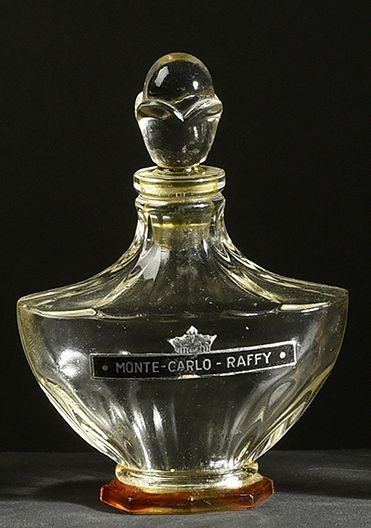 RAFFY «Monte Carlo» - (années 1920)
Flacon en verre incolore pressé moulé de section...